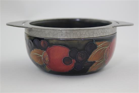 A Moorcroft pomegranate and Tudric pewter mounted quaich, 1920s, 13.8cm